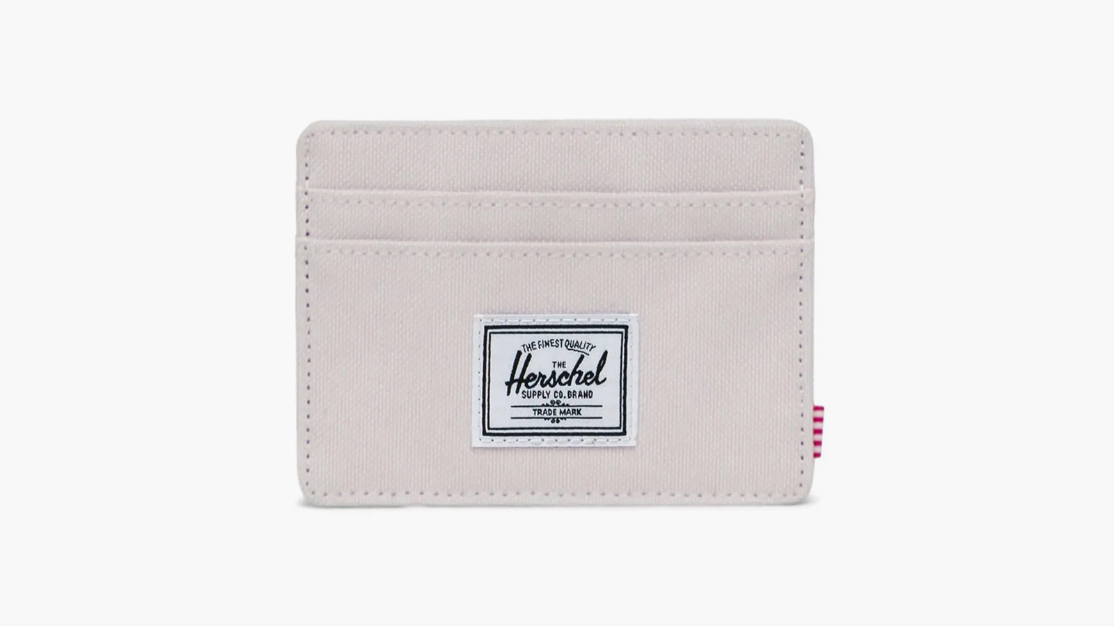 Compact canvas cardholder with Herschel logo—laid-back style meets function in best minimalist wallets for men 2025.