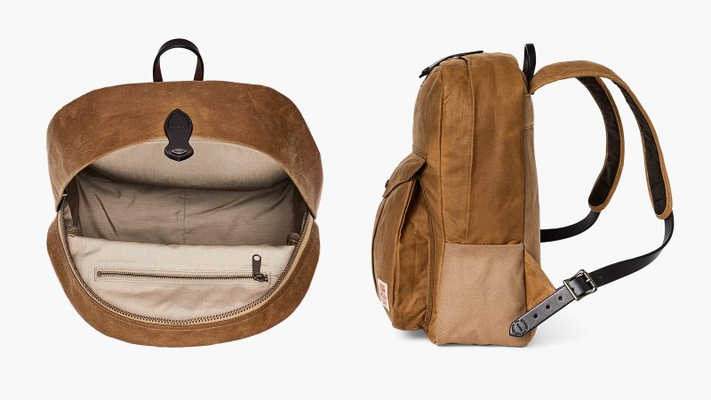 The Filson Journeyman Backpack is crafted from durable Tin Cloth construction, with a padded laptop sleeve, and classic leather detailing for rugged elegance.