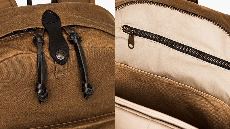 The Filson Journeyman Backpack is crafted from durable Tin Cloth construction, with a padded laptop sleeve, and classic leather detailing for rugged elegance.