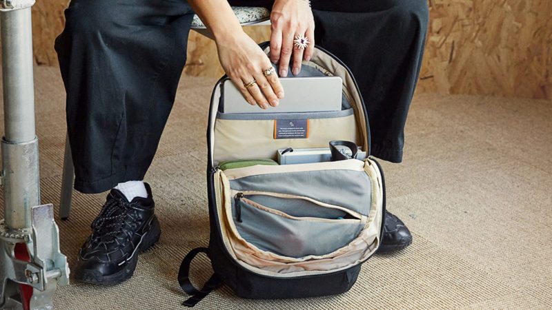 Open commuter backpack showing laptop, EDC, and tech storage – essential organizational setup for those seeking the best commuter gear for men.