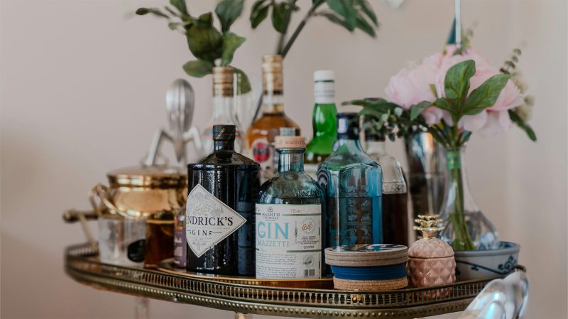 Bottles of liquor on a a metal bar cart 