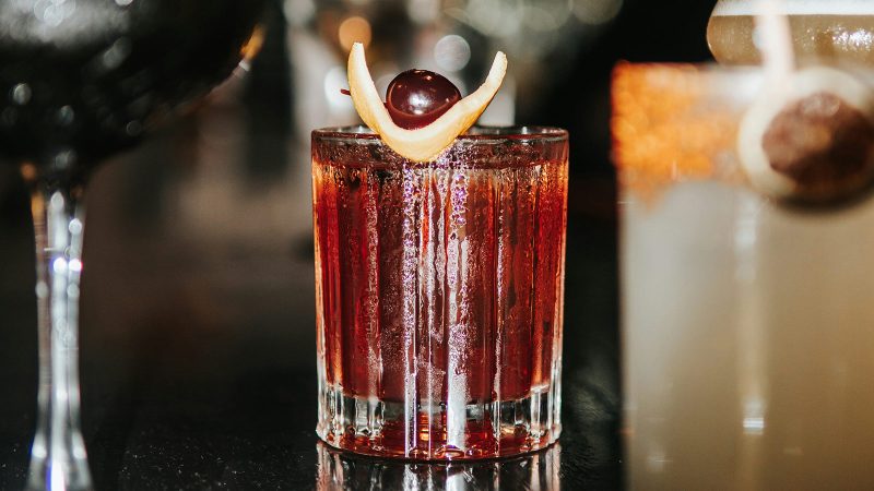 A cocktail with fruit garnish