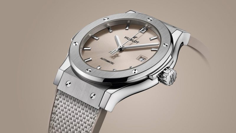 Hublot Classic Fusion Essential Taupe in titanium with sunburst taupe dial, polished bezel, and textured strap in 42mm and 45mm sizes.