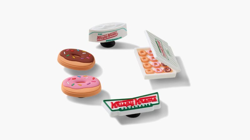 Krispy Kreme x Crocs Classic Clogs feature donut glaze-inspired design, sprinkle-themed Jibbitz charms, and co-branded heel straps.
