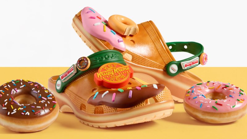 Krispy Kreme x Crocs Classic Clogs feature donut glaze-inspired design, sprinkle-themed Jibbitz charms, and co-branded heel straps.