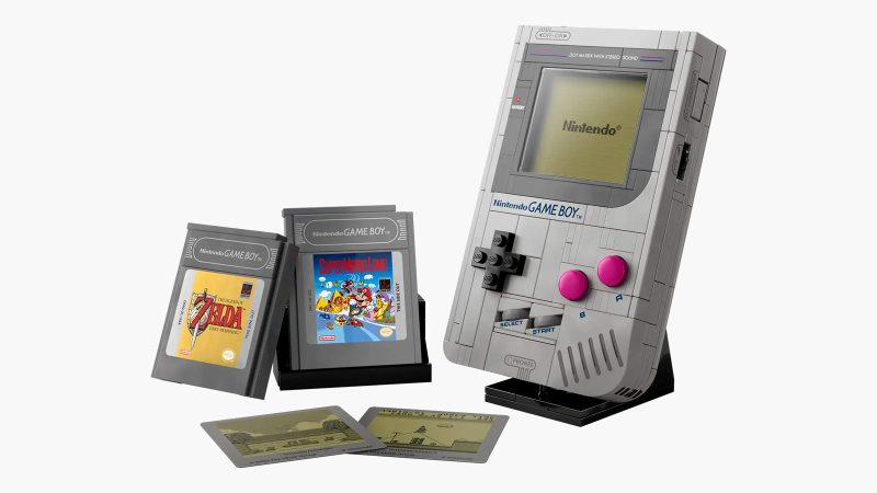 LEGO Game Boy model kit with 421 pieces shown assembled, featuring accurate buttons, interchangeable Zelda and Mario cartridges, lenticular screen options, and a custom display stand—perfect for retro gaming fans and collectors.