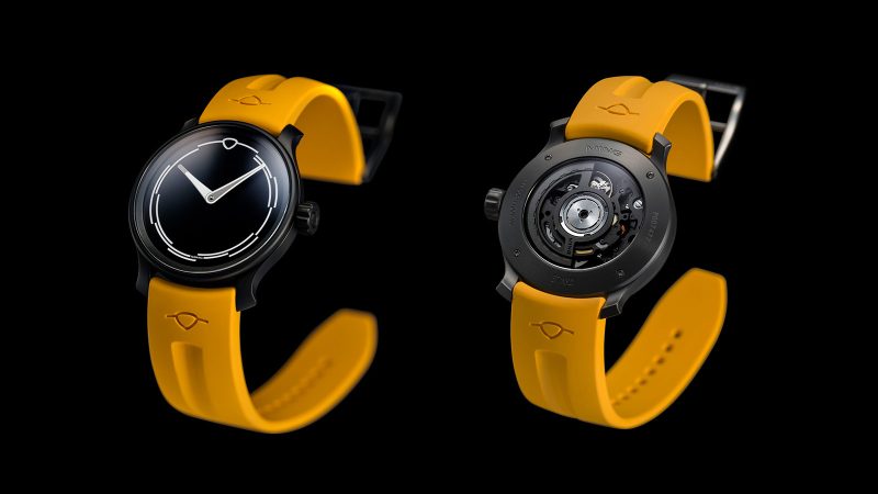 The MING 37.02 Monolith limited-edition DLC-coated minimalist watch with luminous sapphire dial, Sellita SW300.M1 movement, and mango FKM rubber strap.