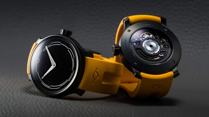 The MING 37.02 Monolith limited-edition DLC-coated minimalist watch with luminous sapphire dial, Sellita SW300.M1 movement, and mango FKM rubber strap.