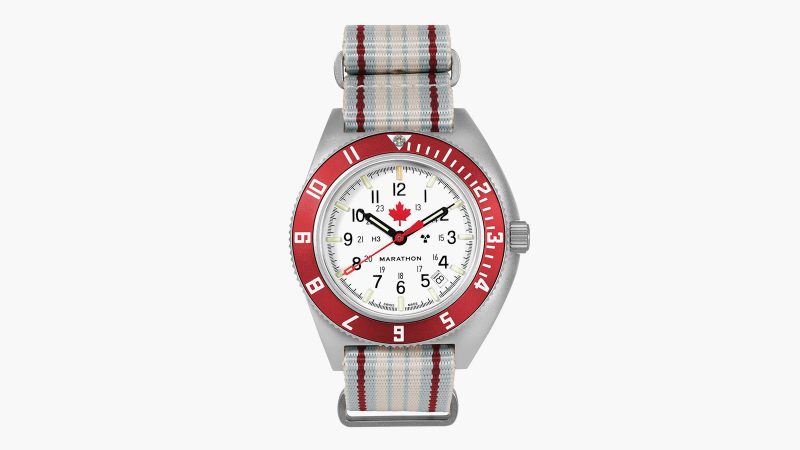 The Marathon ADANAC Navigator Pilot’s Automatic Watch features a red maple leaf on an Arctic white dial, a stainless steel case, and a red 12-hour GMT bezel.