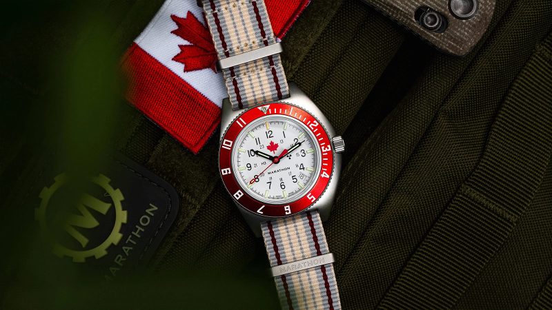 The Marathon ADANAC Navigator Pilot’s Automatic Watch features a red maple leaf on an Arctic white dial, a stainless steel case, and a red 12-hour GMT bezel.