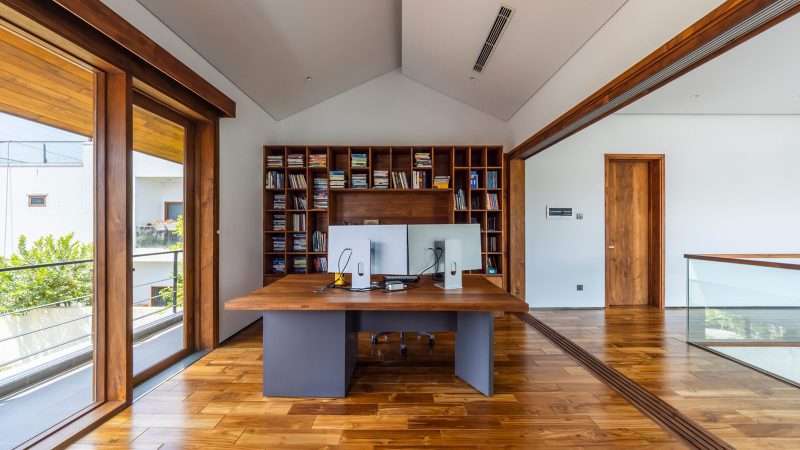 Exterior and interior views of OM House by AN NAM Architecture, showcasing sustainable sandstone walls, verdant gardens, and minimalist modern Vietnamese architecture designed for tranquility.