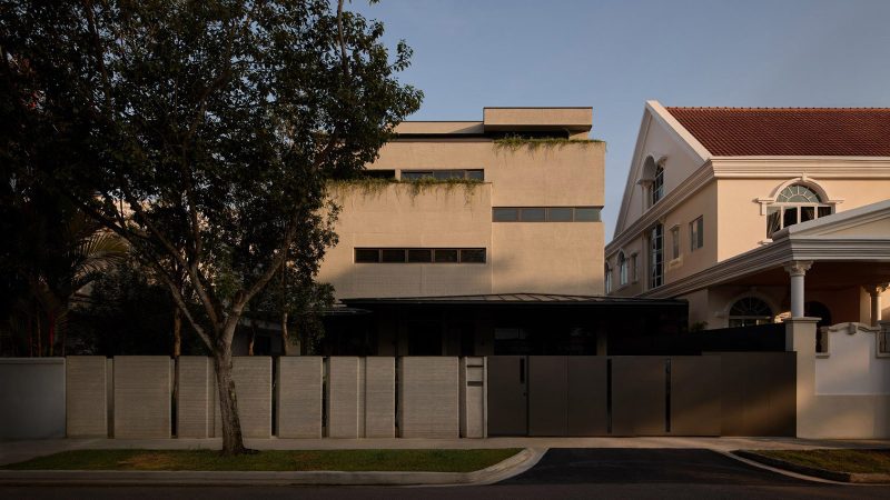The exterior of the QR3D 3D-printed concrete four-story house in Singapore shows layered striations and a central oculus skylight.
