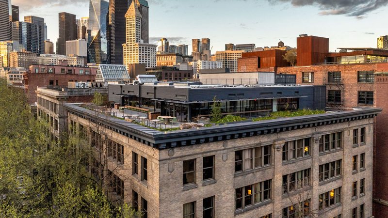 Populus Seattle Hotel showcases sleek minimalist architecture with floor-to-ceiling windows, natural materials, and panoramic views—perfect for modern travelers seeking smart luxury and design-forward accommodations.
