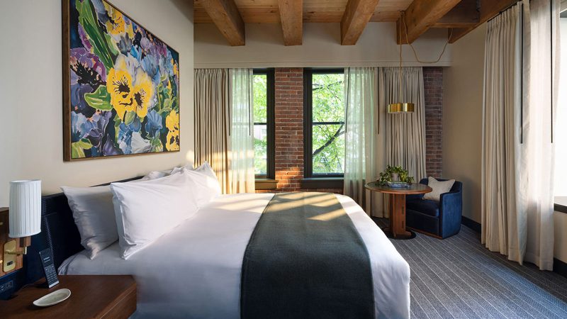 Populus Seattle Hotel showcases sleek minimalist architecture with floor-to-ceiling windows, natural materials, and panoramic views—perfect for modern travelers seeking smart luxury and design-forward accommodations.