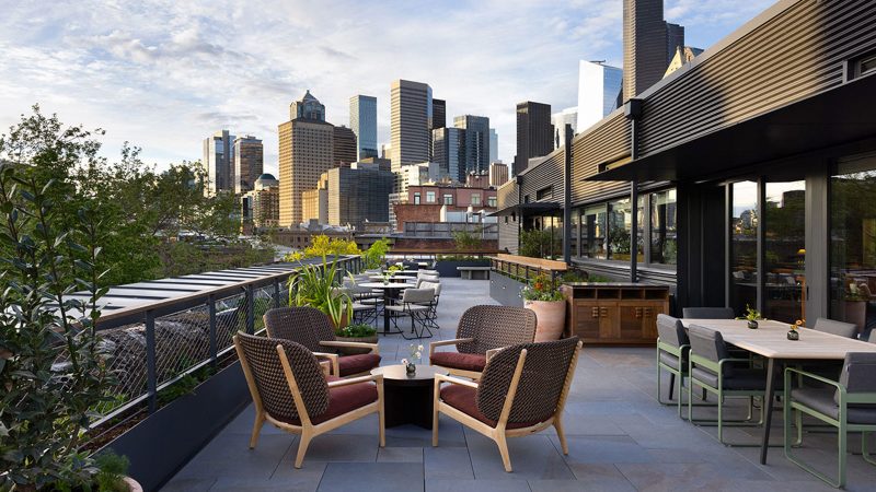 Populus Seattle Hotel showcases sleek minimalist architecture with floor-to-ceiling windows, natural materials, and panoramic views—perfect for modern travelers seeking smart luxury and design-forward accommodations.
