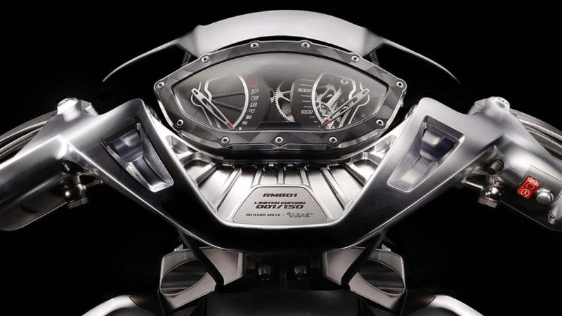 RMB01 track motorcycle by Richard Mille and Brough Superior with exposed carbon frame, gear‑inspired rims, and watch‑style instrument cluster.
