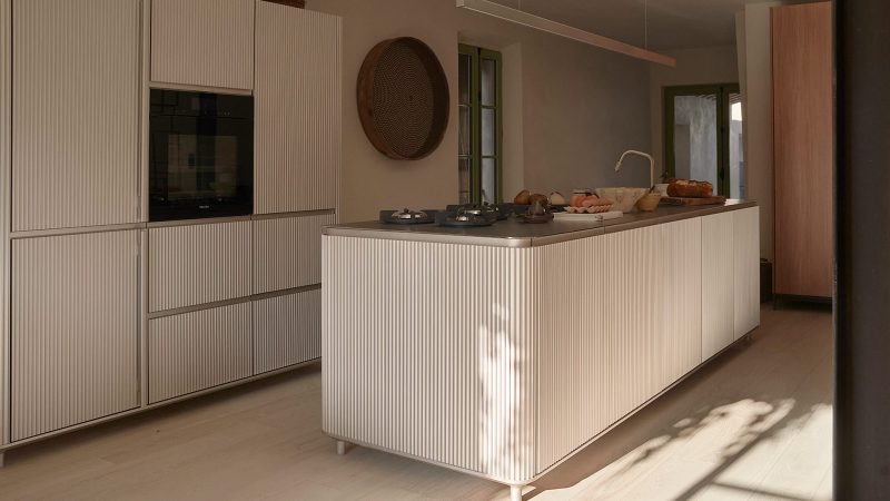 Exterior and interior of Vipp Townhouse in Lagrasse: historic 14th-century stone walls blend with minimalist Scandinavian furnishings and modern marble details.