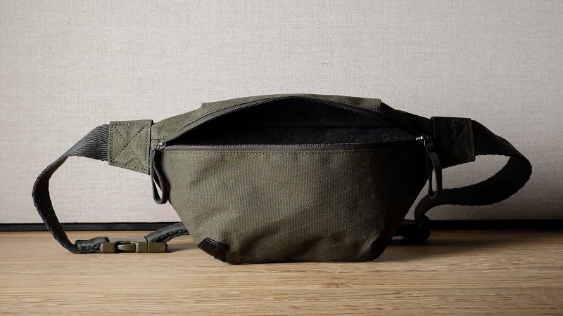 Hardgraft Closest Ally Belt Bag, crafted from weatherproof X-Pac® cotton laminate with Italian leather, features an adjustable strap and a wool-lined interior, made in Italy.
