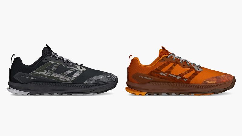 Altra x and wander Lone Peak 9+ trail shoe with alpine graphic overlays, Vibram Megagrip outsole, zero-drop platform, and bold orange and black colorways.