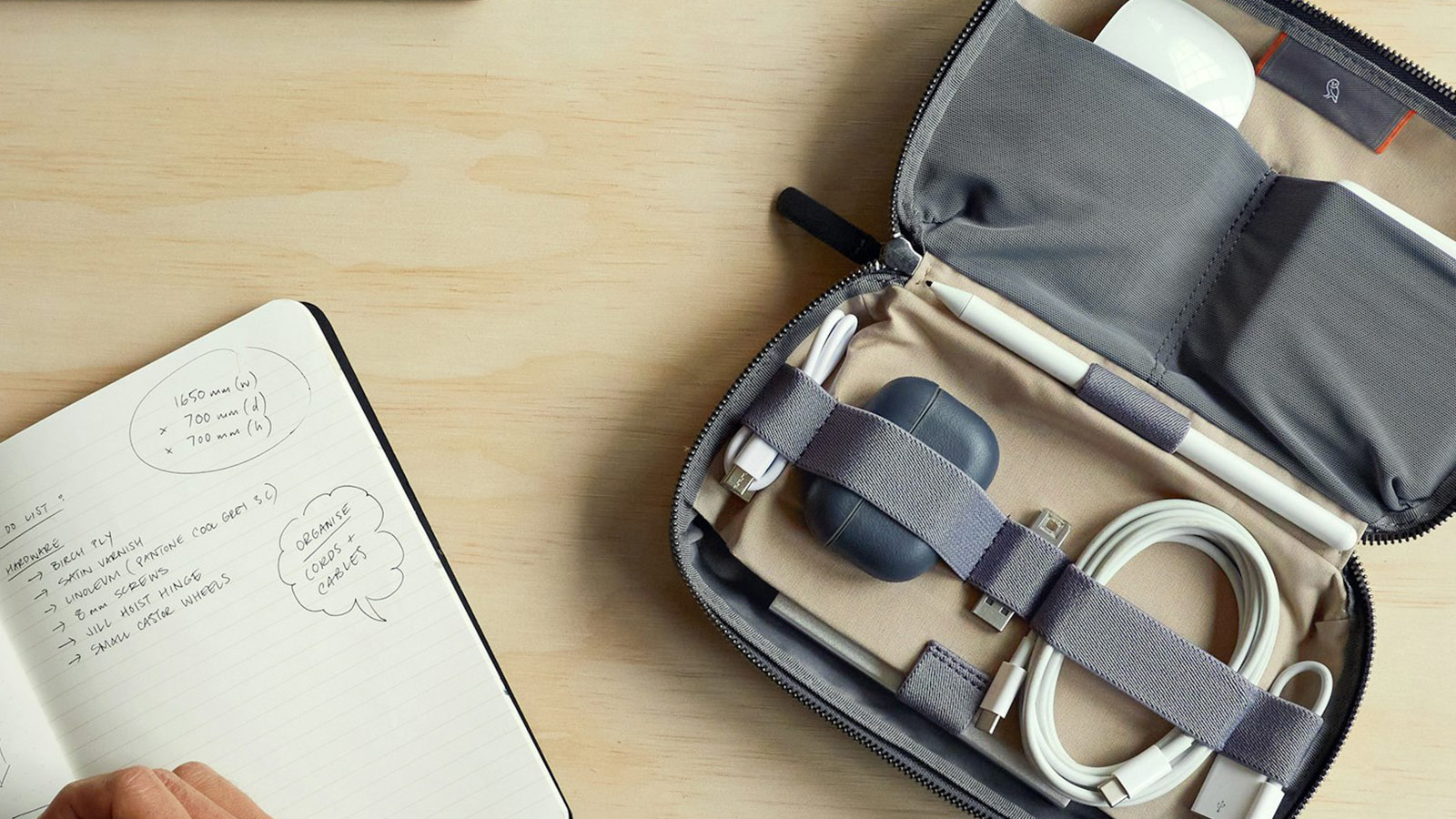 Bellroy Tech Kit open on desk next to notebook – Best Bellroy Everyday Carry Gear for organized work setups