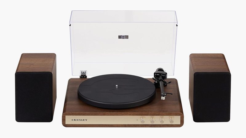 The Crosley C65 Record Player boasts a sleek wood base, dual-speed vinyl playback, and minimalist design delivering stylish, modern sound performance.