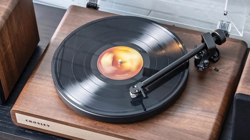 The Crosley C65 Record Player boasts a sleek wood base, dual-speed vinyl playback, and minimalist design delivering stylish, modern sound performance.