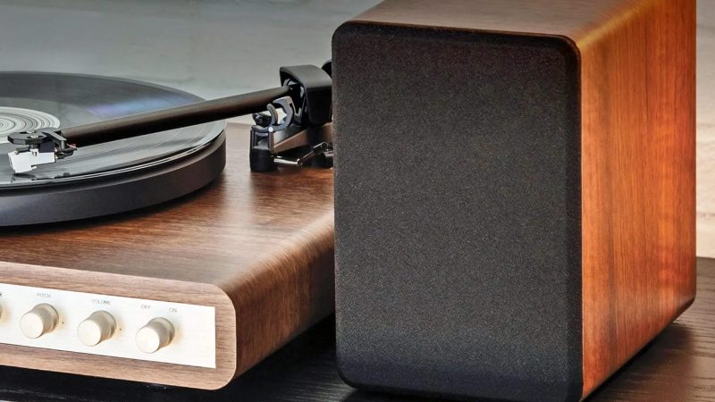 The Crosley C65 Record Player boasts a sleek wood base, dual-speed vinyl playback, and minimalist design delivering stylish, modern sound performance.