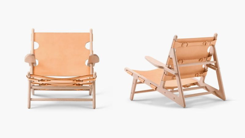The Fredericia Hunting Chair in soaped oak with saddle leather, designed by Børge Mogensen, showcases minimalist Danish craftsmanship and luxury seating.