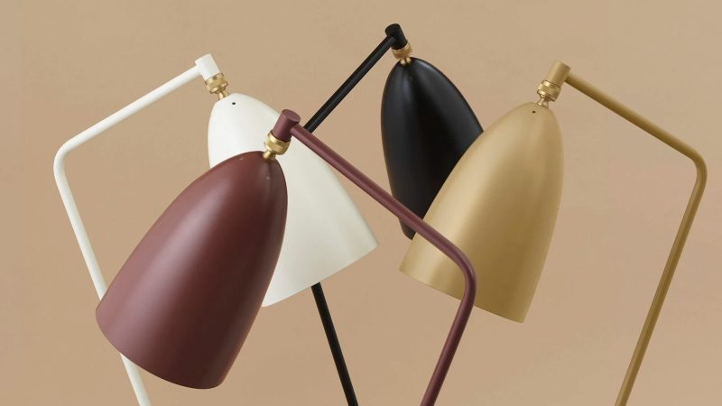 The GUBI Gräshoppa Floor Lamp boasts a tilted tripod base, an adjustable ball-joint shade, and mid-century Scandinavian design.