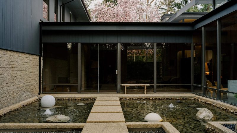 Glass Ridge House by OWIU Design featuring expansive glass walls, koi pond entry, and serene East-meets-West architectural details.