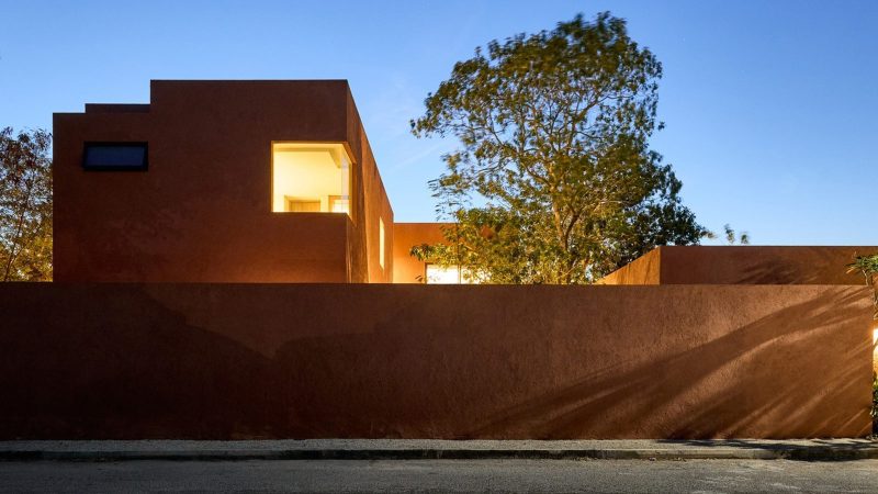 K’ab House by Lessmore Group, a Yucatán residence that combines rustic terracotta blocks, glass details, and lush greenery into a serene architectural retreat.