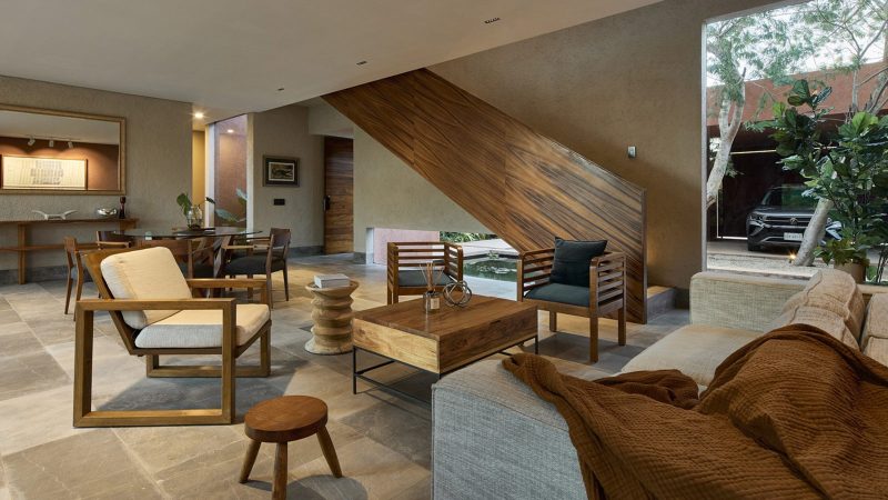 K’ab House by Lessmore Group, a Yucatán residence that combines rustic terracotta blocks, glass details, and lush greenery into a serene architectural retreat.