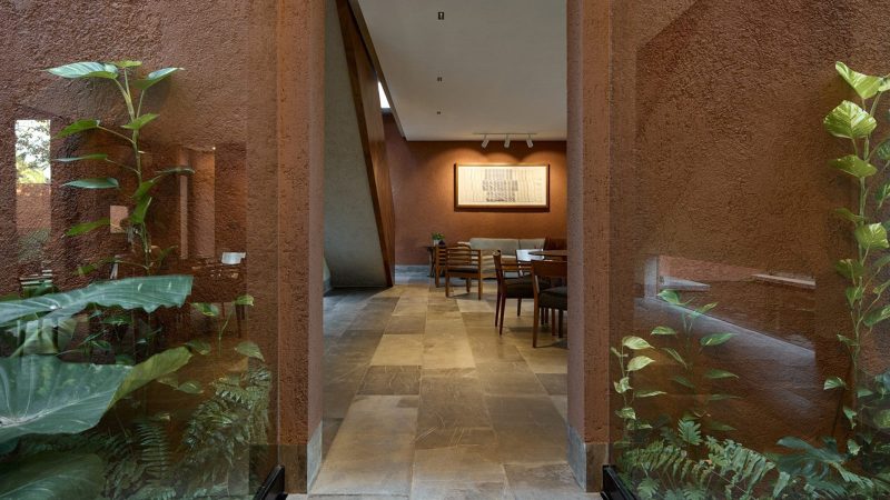 K’ab House by Lessmore Group, a Yucatán residence that combines rustic terracotta blocks, glass details, and lush greenery into a serene architectural retreat.