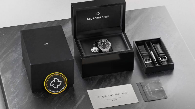 Micromilspec Dualtimer GMT pilot watch in brushed stainless steel with dual-color lume, Swiss automatic movement, and 24-hour rotating bezel.