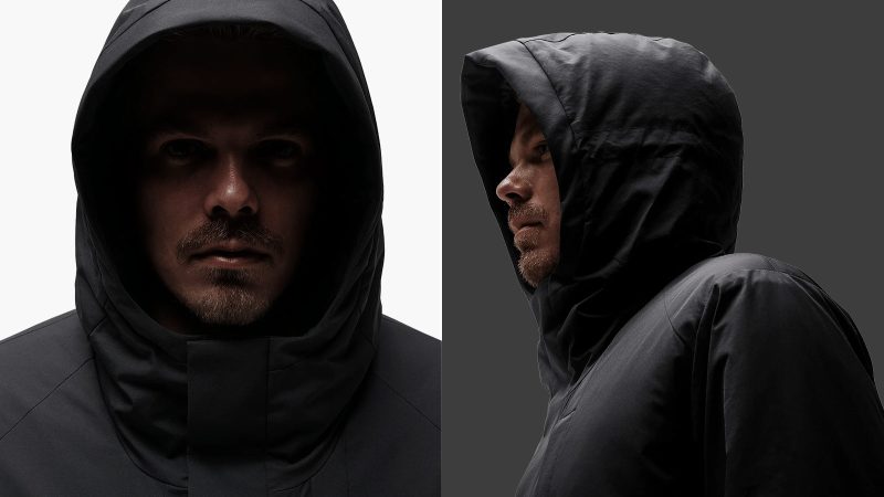 SPC/LST Revenant Weatherproof Parka in black with oversized fit and drop-tail hem, showcasing recycled materials, PrimaLoft insulation, and technical weatherproof design.