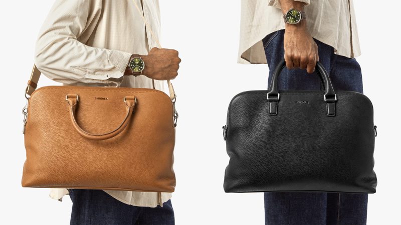 Shinola Double Zip Briefcase in premium Navigator leather with dual compartments, a padded laptop sleeve, and an adjustable strap for work and travel.