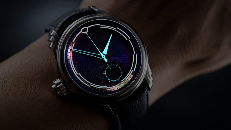 Ming 57.04 Iris left-handed monopusher chronograph with color-shifting Iris-effect dial, sculptural steel case, and Swiss hand-wound movement.