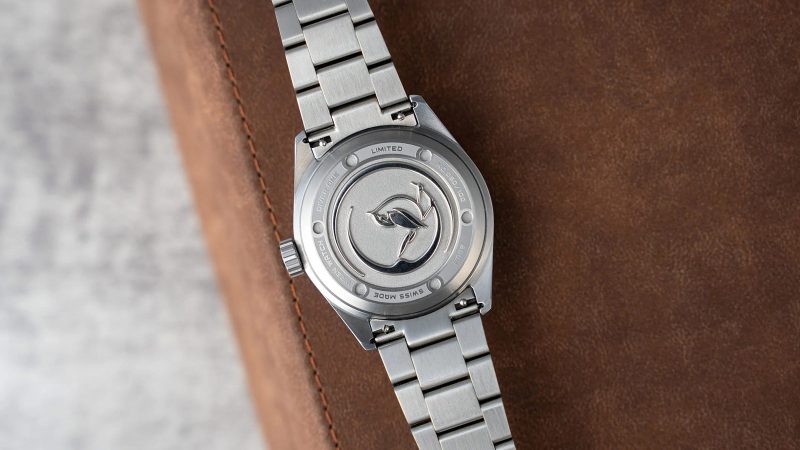 The Wren Diver One Magma shows its fiery lava-inspired fumé dial, ceramic bezel, and stainless-steel case with black lume accents.