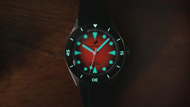 The Wren Diver One Magma shows its fiery lava-inspired fumé dial, ceramic bezel, and stainless-steel case with black lume accents.
