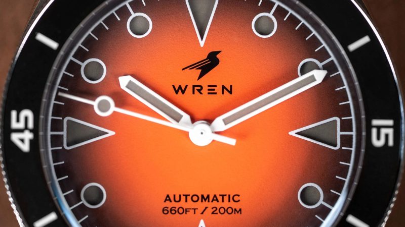 The Wren Diver One Magma shows its fiery lava-inspired fumé dial, ceramic bezel, and stainless-steel case with black lume accents.