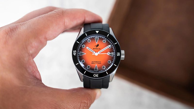 The Wren Diver One Magma shows its fiery lava-inspired fumé dial, ceramic bezel, and stainless-steel case with black lume accents.