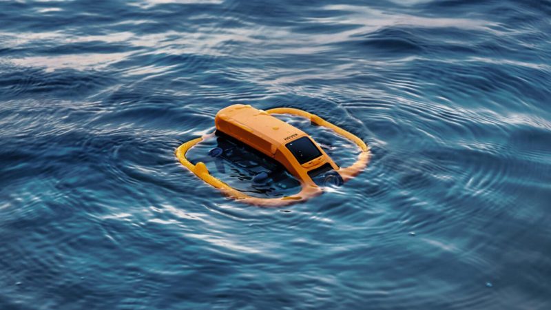 HoverAir Aqua drone can float upright on the water’s surface with an orange buoyant frame.