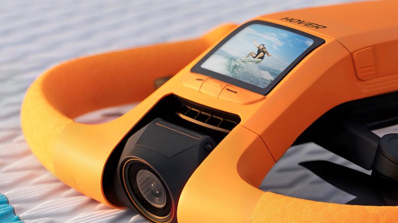 HoverAir Aqua drone can float upright on the water’s surface with an orange buoyant frame.