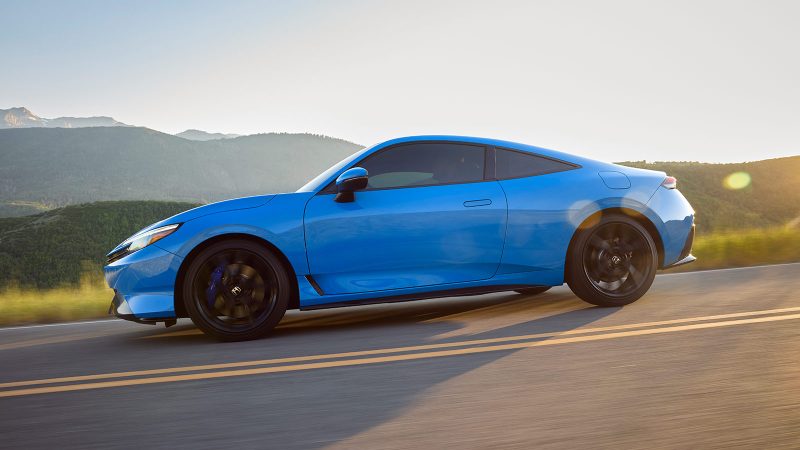 The 2026 Honda Prelude hybrid-electric sports coupe features a wide stance, flared fenders, Berlina Black wheels, and sleek GT styling.