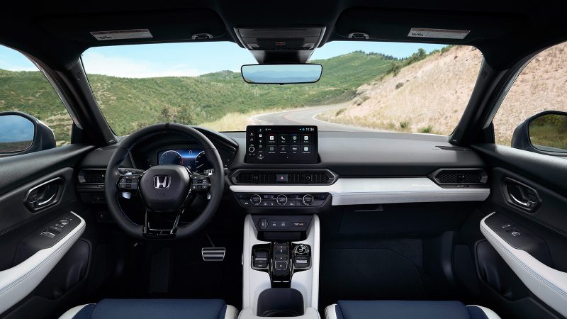 The 2026 Honda Prelude hybrid-electric sports coupe features a wide stance, flared fenders, Berlina Black wheels, and sleek GT styling.