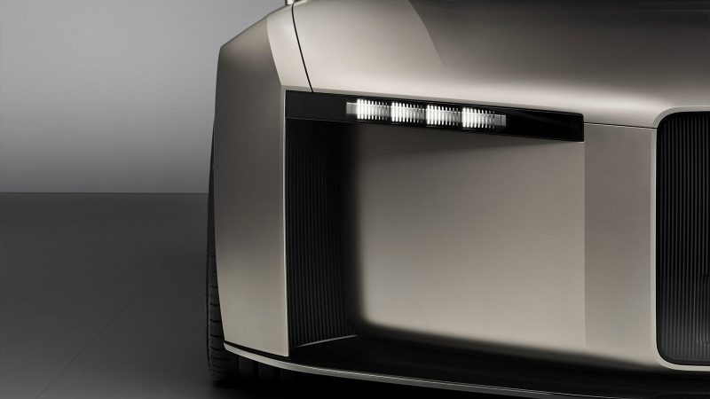 The Audi Concept C is an all-electric two-seat roadster featuring a vertical frame grille, a titanium finish, and a retractable hardtop, showcasing Audi’s next-generation design.