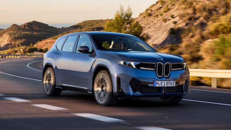 The 2026 BMW iX3, an all-electric SUV, showcases the Neue Klasse design with its slim kidney grilles, wagon-like stance, and futuristic Panoramic iDrive interior.