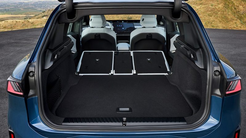 The 2026 BMW iX3, an all-electric SUV, showcases the Neue Klasse design with its slim kidney grilles, wagon-like stance, and futuristic Panoramic iDrive interior.