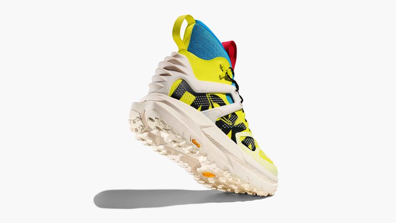 HOKA Mafate X Hike hiking boot in Citrus/Alabaster colorway with carbon fiber plate, RECCO reflector technology, neoprene collar, and cushioned outsole.