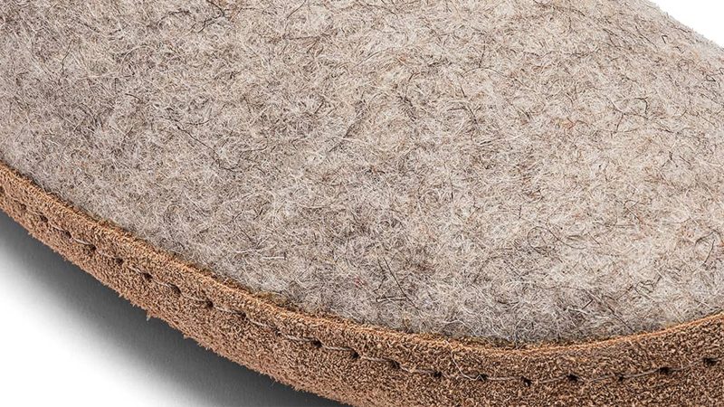 Kyrgies Indoor Wool Slides are minimalist house shoes crafted from sustainable materials with a slip-on design and artisanal construction.